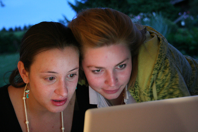 To jenter som stirrer på en skjerm.