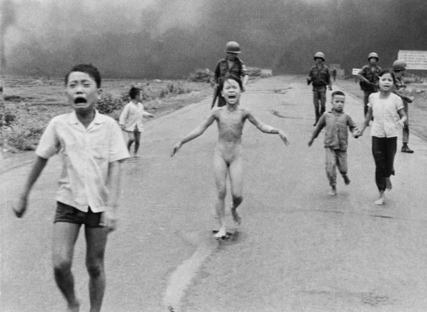FILE - In this June 8, 1972 file photo, South Vietnamese forces follow after terrified children, including 9-year-old Kim Phuc, center, as they run down Route 1 near Trang Bang after an aerial napalm attack on suspected Viet Cong hiding places. A South Vietnamese plane accidentally dropped its flaming napalm on South Vietnamese troops and civilians. The terrified girl had ripped off her burning clothes while fleeing. The children from left to right are: Phan Thanh Tam, younger brother of Kim Phuc, who lost an eye, Phan Thanh Phouc, youngest brother of Kim Phuc, Kim Phuc, and Kim's cousins Ho Van Bon, and Ho Thi Ting. Behind them are soldiers of the Vietnam Army 25th Division. (AP Photo/Nick Ut, File)